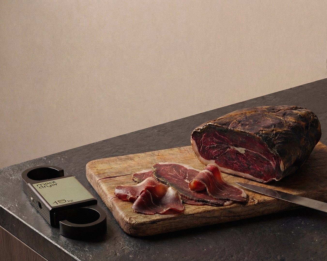 Sliced cured meat on a wooden cutting board with a meatdryer digital thermometer, humidity meater and smart weight scale on a dark surface.